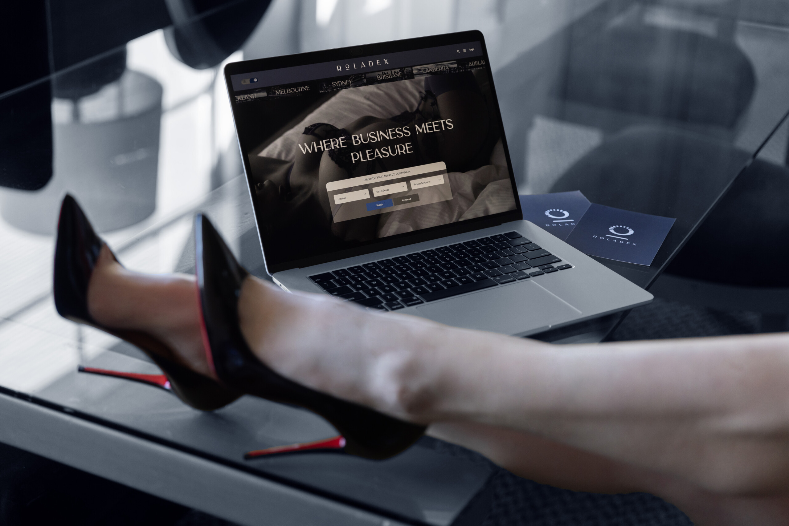 Roladex heels on table laptop